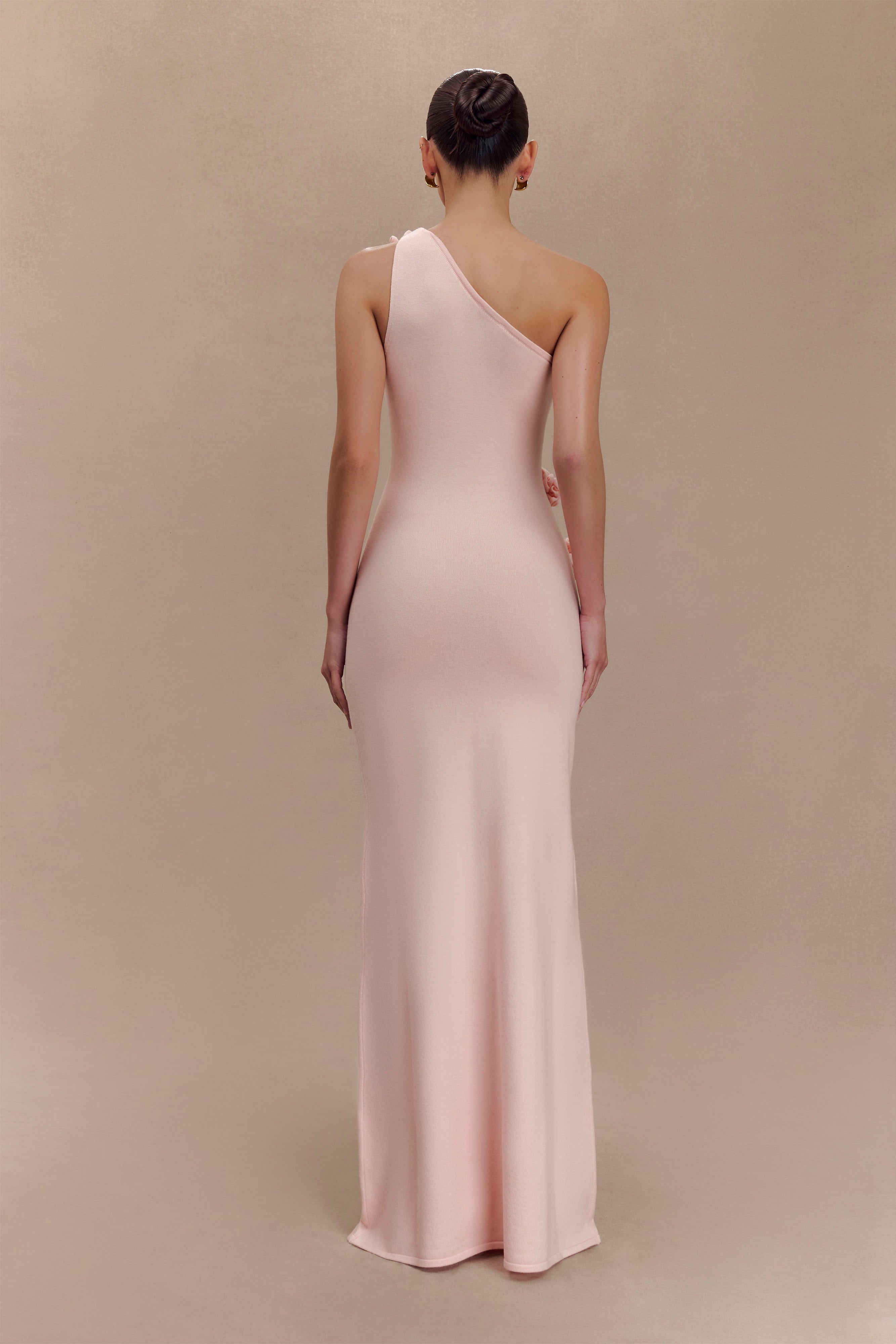 Woman wearing pale pink one-shoulder knit maxi dress, back view against neutral background — Meshki | Endless UAE