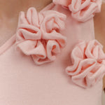 Woman wearing pale pink one-shoulder knit maxi dress, back view against neutral background — Meshki | Endless UAE