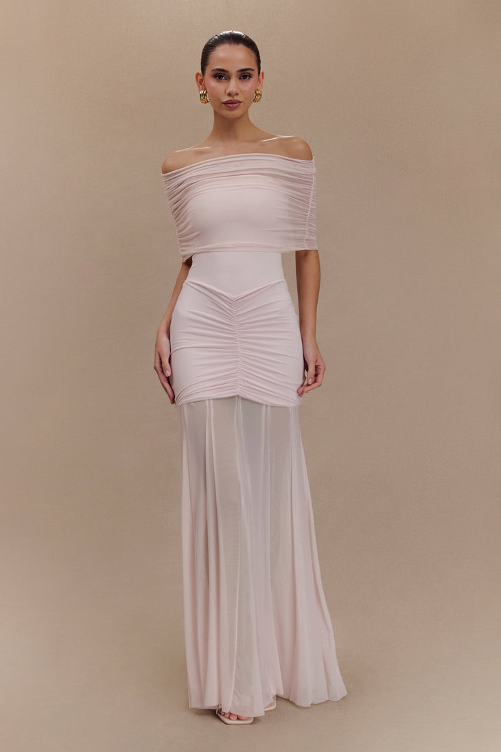 Woman wearing blush off-shoulder maxi dress with ruched details and mesh panel — Meshki | Endless UAE