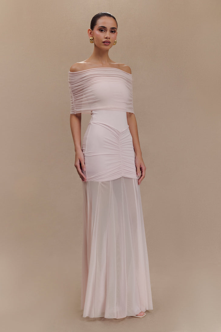 Woman wearing blush off-shoulder maxi dress with ruched details and mesh panel — Meshki | Endless UAE