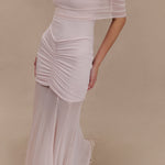 Woman wearing blush off-shoulder maxi dress with ruched details and mesh panel — Meshki | Endless UAE