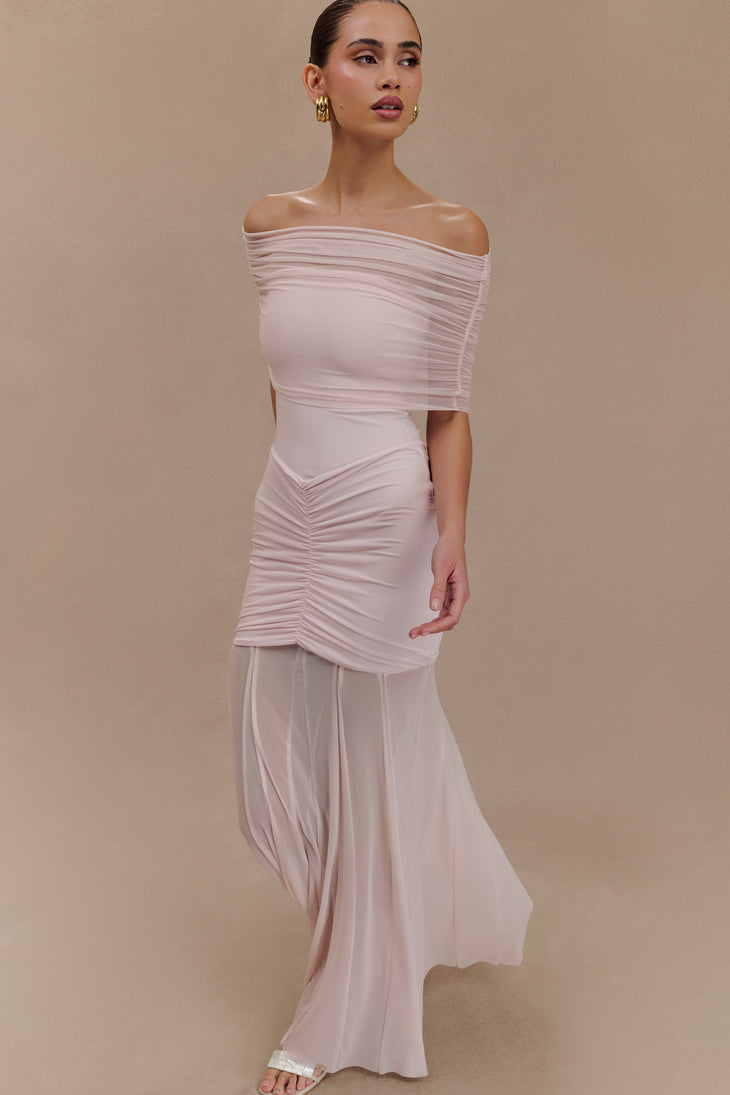 Woman wearing blush off-shoulder maxi dress with ruched details and mesh panel — Meshki | Endless UAE