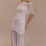 Woman wearing blush off-shoulder maxi dress with ruched details and mesh panel — Meshki | Endless UAE