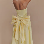 Elegant pale yellow strapless maxi dress featuring a dramatic oversized bow detail at the back waist — Meshki | Endless UAE