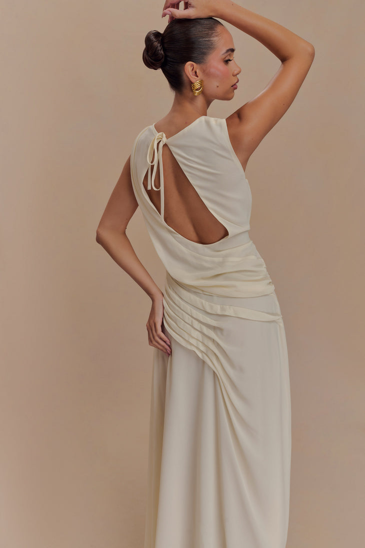 Elegant ivory chiffon maxi dress with open back cutout and tie detail, worn by model in side profile — Meshki | Endless UAE