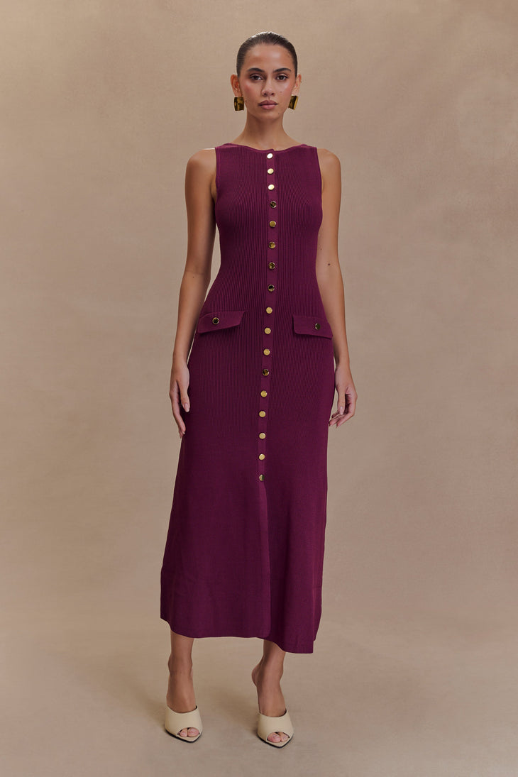 Woman wearing burgundy sleeveless ribbed maxi dress with gold button front detail and flap pockets — Meshki | Endless UAE
