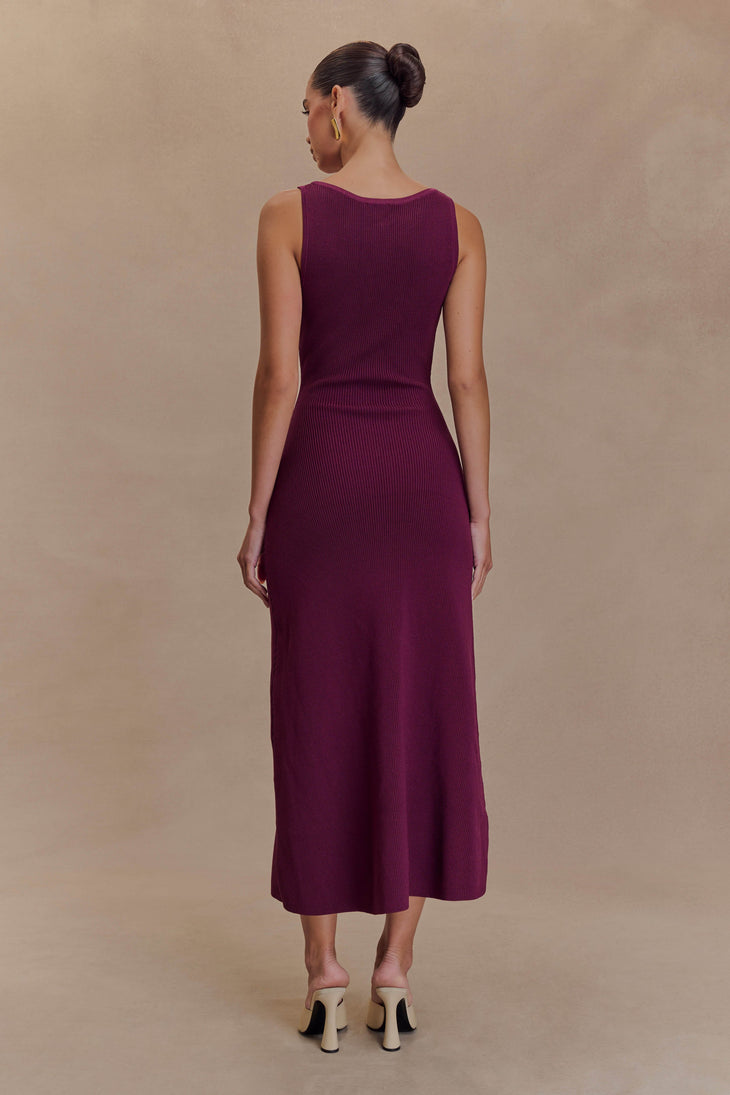Woman wearing burgundy ribbed sleeveless maxi dress with button detail, back view, paired with beige heels — Meshki | Endless UAE