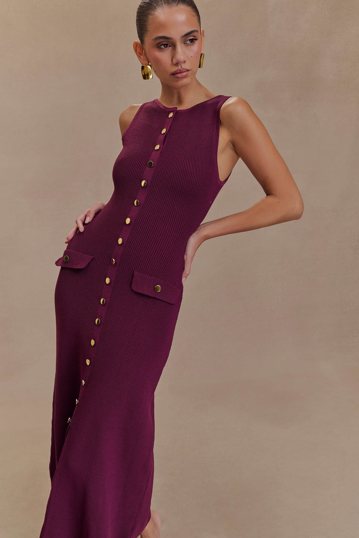 Woman wearing burgundy ribbed sleeveless maxi dress with gold button front detail and utility pockets — Meshki | Endless UAE