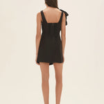 Black wrap mini dress with dramatic shoulder ruffle and feathered heels — Aje | Endless UAE
