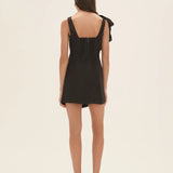 Black wrap mini dress with dramatic shoulder ruffle and feathered heels — Aje | Endless UAE