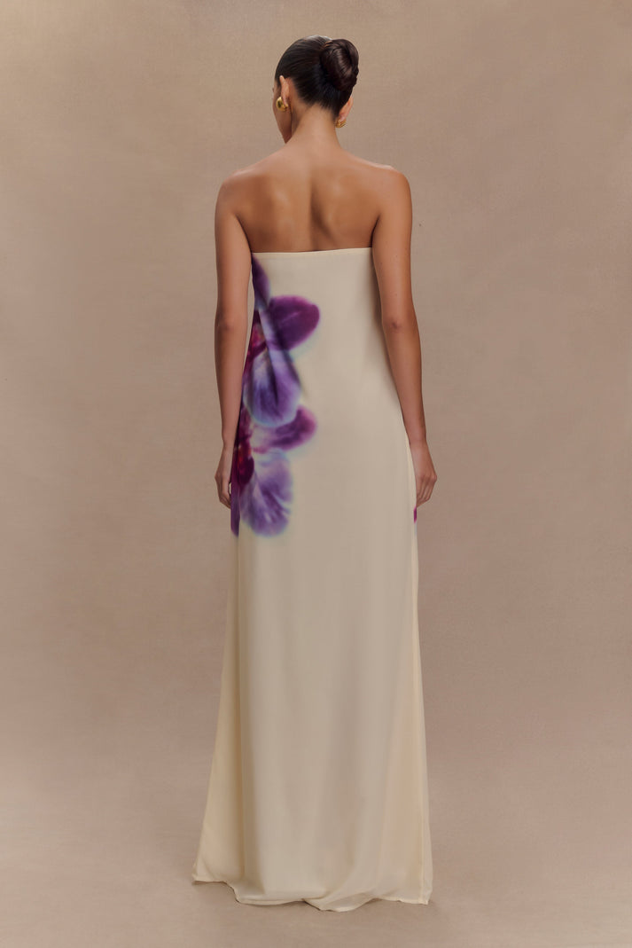 Elegant strapless cream maxi dress with purple watercolor floral print, shown from back on model with hair in updo — Meshki | Endless UAE