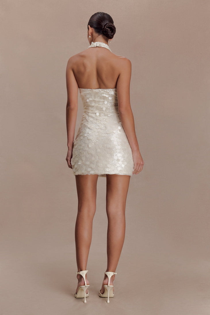 Woman wearing ivory sequin halter dress with open back, shown from rear view — Meshki | Endless UAE
