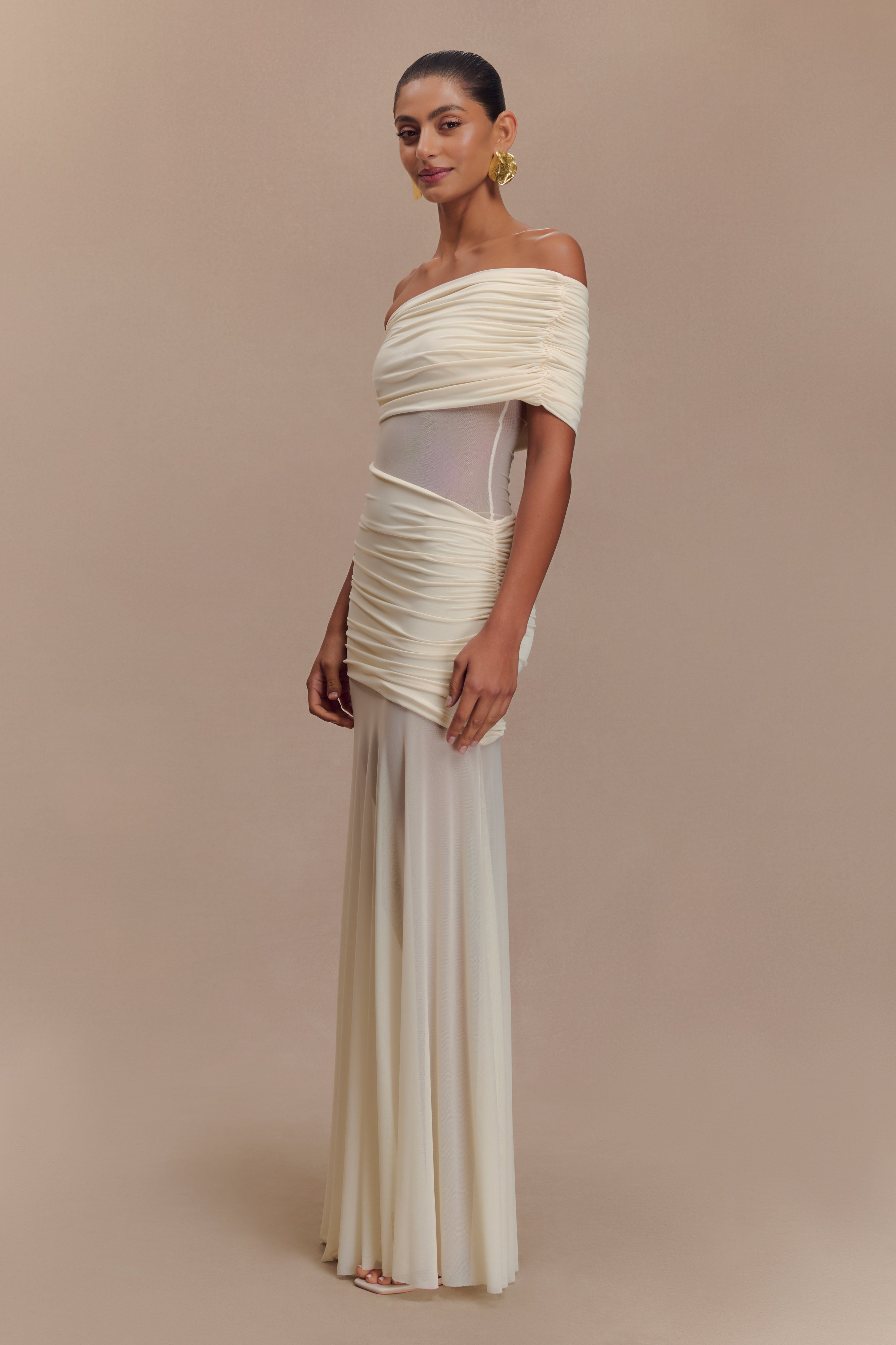 Elegant off-white mesh maxi dress with ruched off-shoulder bodice and flowing silhouette on model — Meshki | Endless UAE