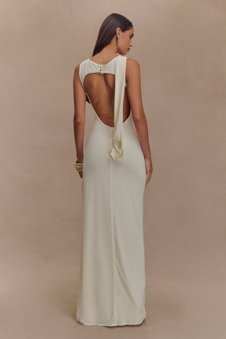 Cream sleeveless maxi dress with open back and drape detail, viewed from behind on model — Meshki | Endless UAE