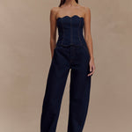 Dark indigo denim strapless corset top with scalloped neckline and exposed contrast stitching paired with matching wide-leg jeans — Meshki | Endless UAE