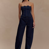 Dark indigo denim strapless corset top with scalloped neckline and exposed contrast stitching paired with matching wide-leg jeans — Meshki | Endless UAE