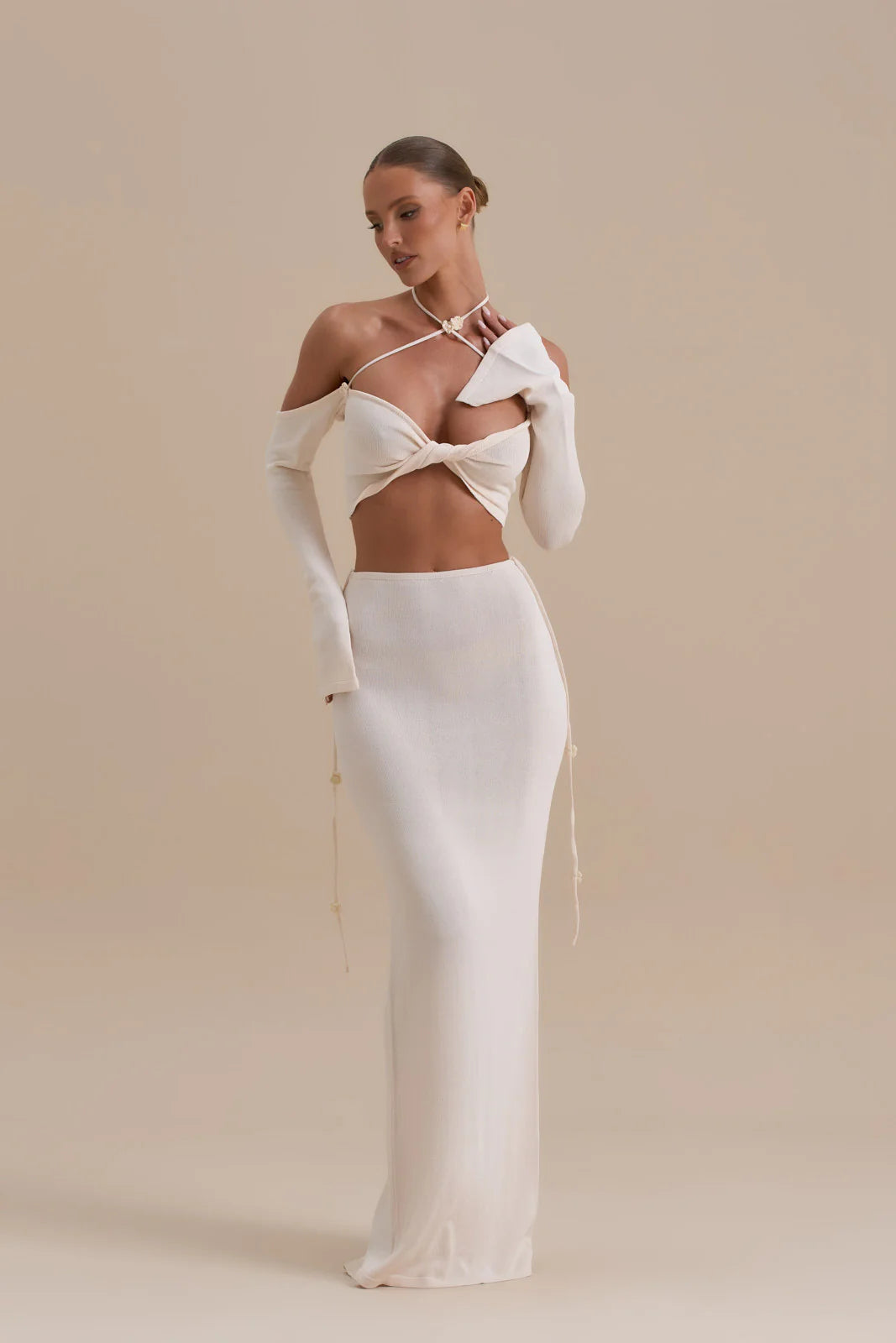 Elegant white two-piece co-ord set with twisted halter crop top and high-waisted maxi skirt — Wanderdoll | Endless UAE