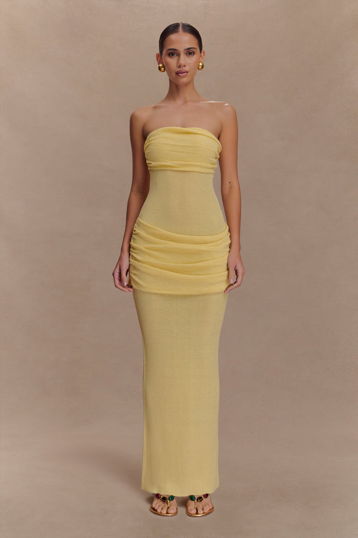 Elora Strapless Knit Maxi Dress in yellow featuring ruched bodice and hip details, worn with gold earrings — Meshki | Endless UAE