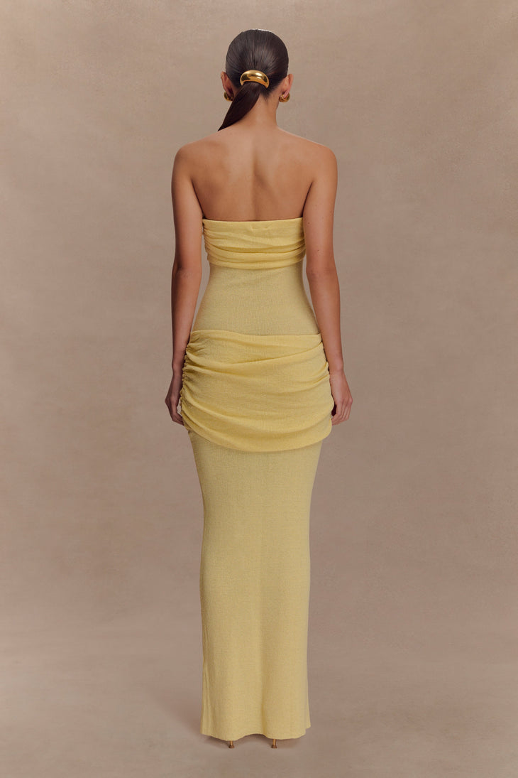 Woman in yellow strapless ruched knit maxi dress, back view, hair in low ponytail with gold clip — Meshki | Endless UAE
