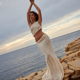 Champagne sequin two-piece set with one-shoulder crop top and maxi skirt on coastal rocks — Label Loft London | Endless UAE
