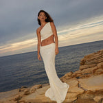 Elegant white sequin two-piece set with one-shoulder crop top and high-waist maxi skirt by ocean at sunset — Label Loft London | Endless UAE