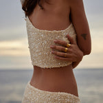 Champagne sequin bandeau top and skirt set worn by woman at beach during sunset — Label Loft London | Endless UAE