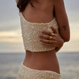 Champagne sequin bandeau top and skirt set worn by woman at beach during sunset — Label Loft London | Endless UAE
