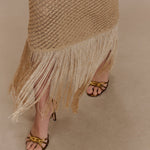 Woman wearing beige metallic knit midi dress with keyhole neckline and fringe hem — Meshki | Endless UAE