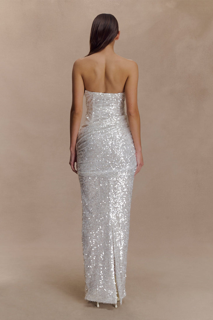 Rear view of woman wearing silver sequin strapless maxi dress with body-hugging silhouette and side slit — Meshki | Endless UAE