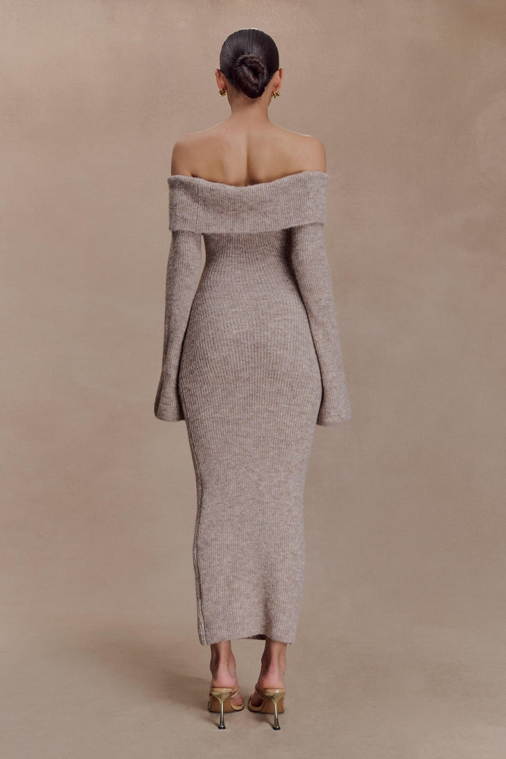 Woman wearing beige off-shoulder ribbed knit midi dress with long sleeves, shown from back, styled with nude heels — Meshki | Endless UAE