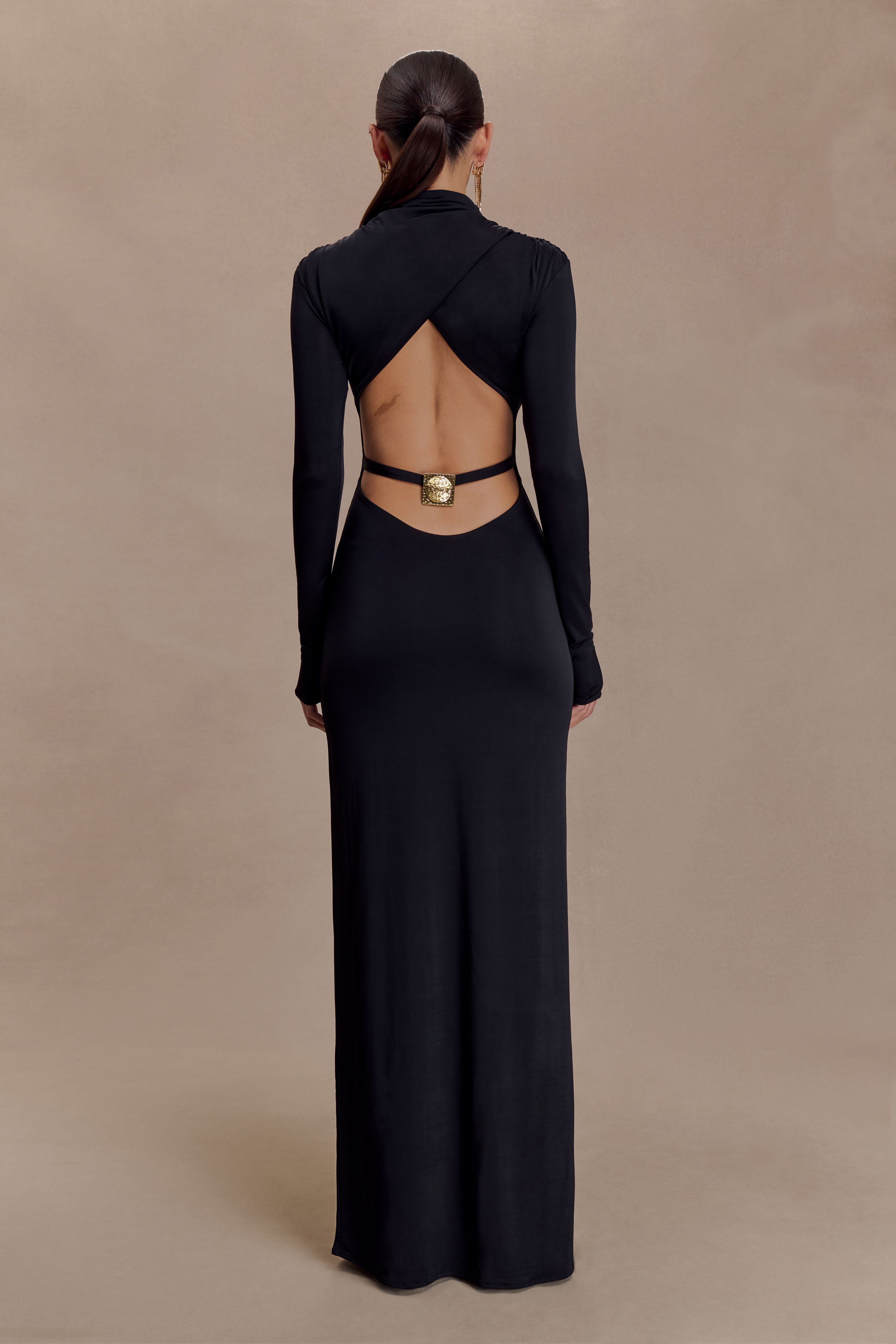 Black long sleeve maxi dress with cut-out back detail and gold belt buckle — Meshki | Endless UAE