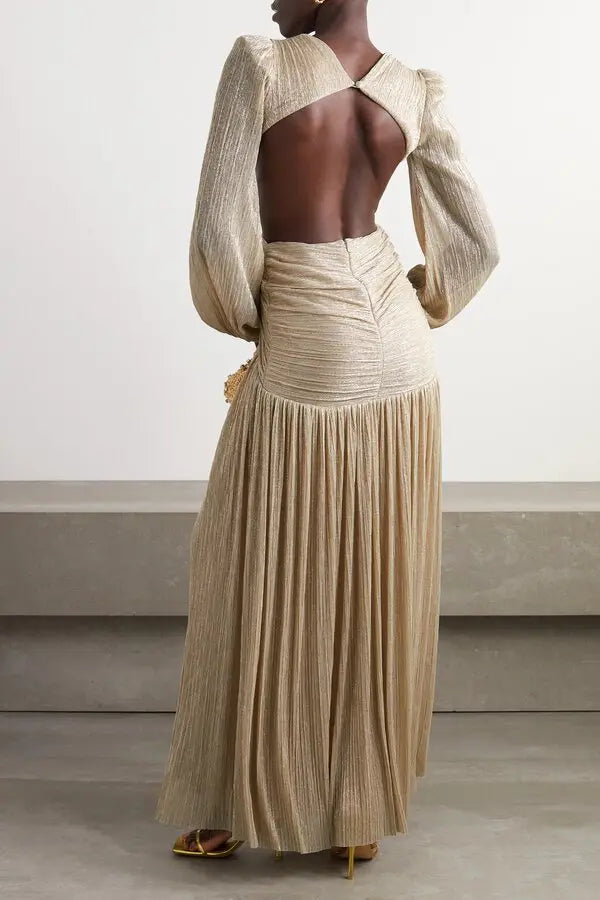 Gold pleated cutout maxi dress with twisted knot detail and long sleeves on model with woven clutch — Patbo | Endless UAE