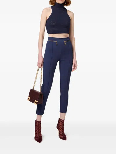 Navy sleeveless turtleneck crop top styled with high-waisted trousers and burgundy accessories — Elisabetta Franchi | Endless UAE