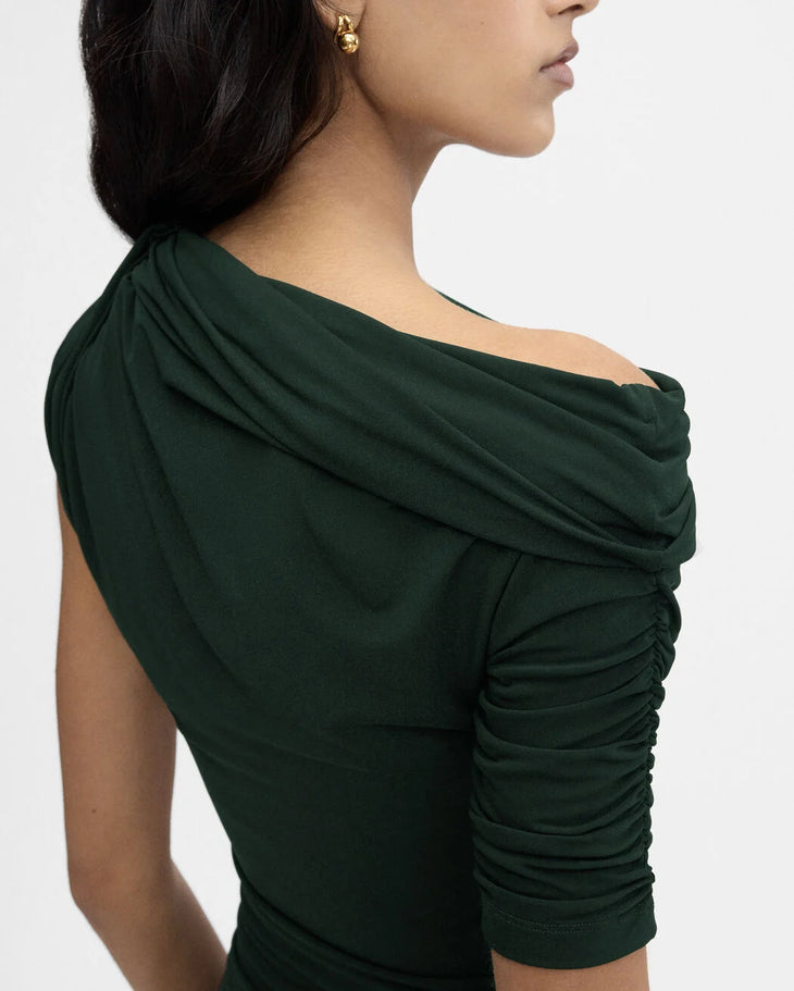 Dark green draped mini dress with asymmetric neckline and ruched detailing, worn by model in profile view — Jacquemus | Endless UAE