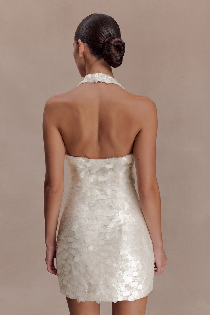 Woman wearing ivory sequin halter dress with open back, shown from rear view — Meshki | Endless UAE