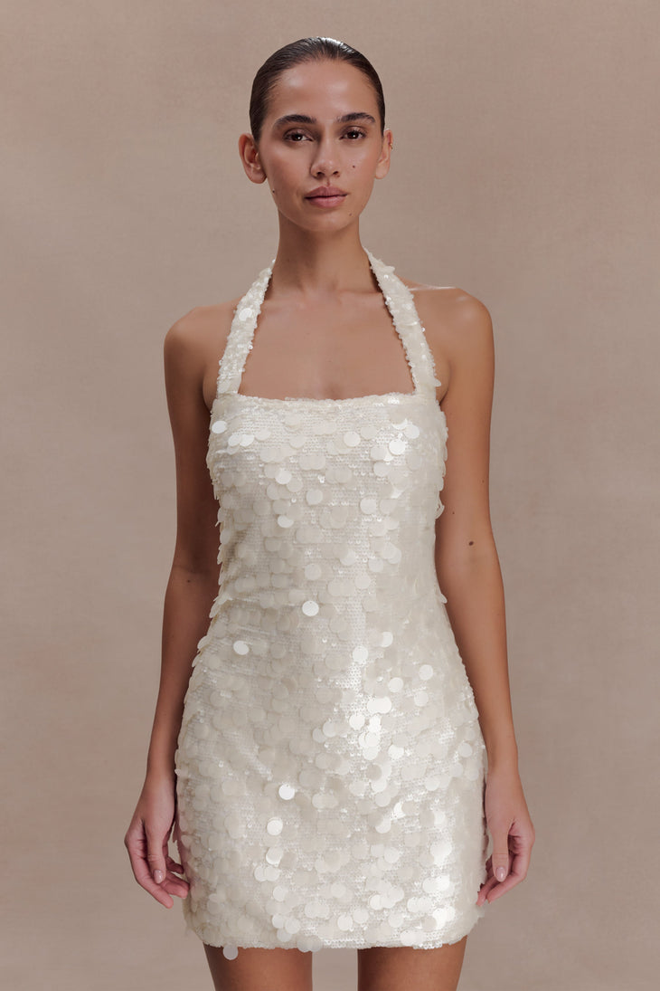 Woman wearing ivory sequin halter dress with open back, shown from rear view — Meshki | Endless UAE