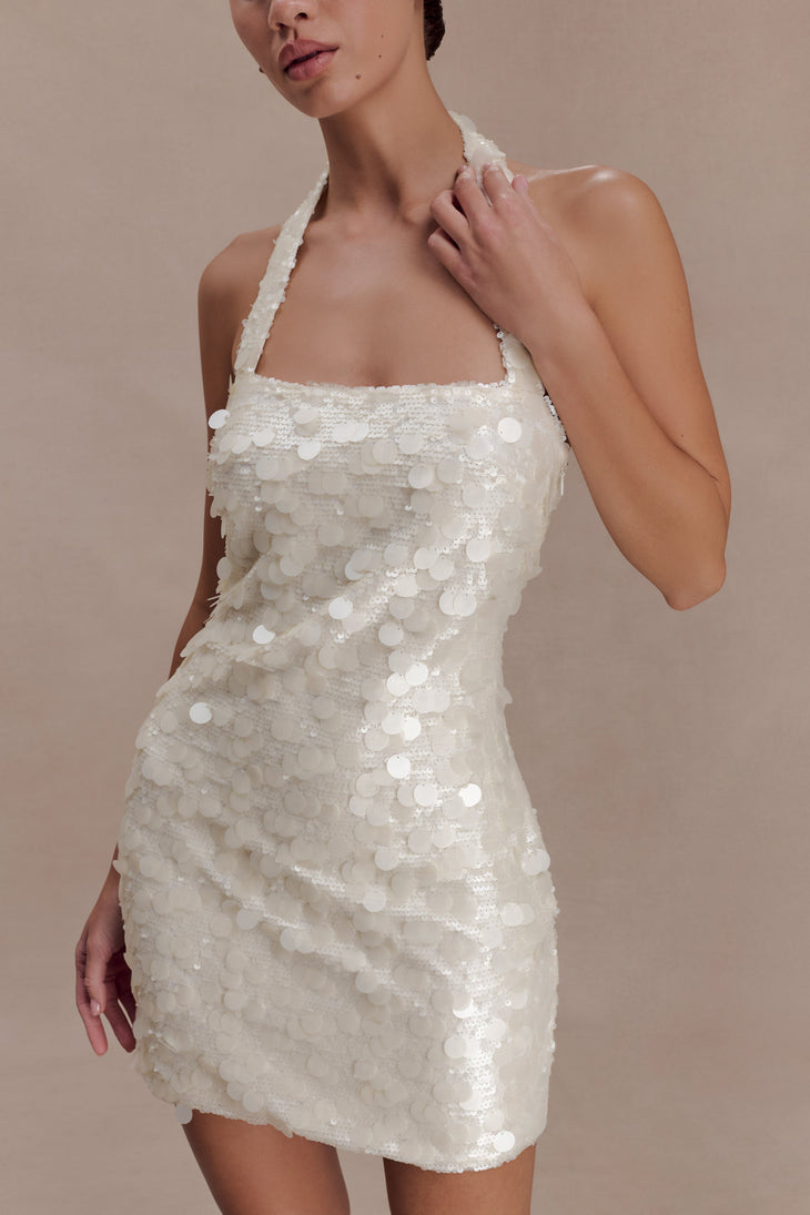 Woman wearing ivory sequin halter dress with open back, shown from rear view — Meshki | Endless UAE