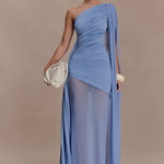 Woman wearing periwinkle blue one shoulder maxi dress with draped fabric detail and cream clutch — Meshki | Endless UAE