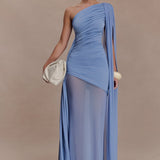 Woman wearing periwinkle blue one shoulder maxi dress with draped fabric detail and cream clutch — Meshki | Endless UAE