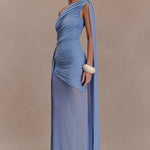 Woman wearing periwinkle blue one shoulder maxi dress with draped fabric detail and cream clutch — Meshki | Endless UAE