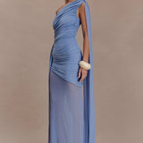 Woman wearing periwinkle blue one shoulder maxi dress with draped fabric detail and cream clutch — Meshki | Endless UAE