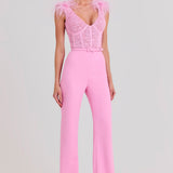 Woman wearing pink Anabelle jumpsuit with sequined bodice and feather shoulders — Nadine Merabi | Endless UAE
