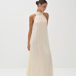 Elegant cream halter neck maxi dress with flowing silhouette and pleated neckline — Nora The Label | Endless UAE