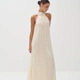 Elegant cream halter neck maxi dress with flowing silhouette and pleated neckline — Nora The Label | Endless UAE