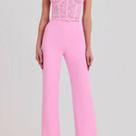 Woman wearing pink Anabelle jumpsuit with sequined bodice and feather shoulders — Nadine Merabi | Endless UAE
