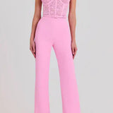 Woman wearing pink Anabelle jumpsuit with sequined bodice and feather shoulders — Nadine Merabi | Endless UAE