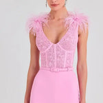 Woman wearing pink Anabelle jumpsuit with sequined bodice and feather shoulders — Nadine Merabi | Endless UAE