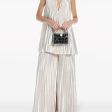 Pleated white halter dress and pants set with black embellished clutch — L'IDÉE | Endless UAE