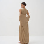 Elegant beige sleeveless bodysuit with matching draped shawl wrap, model shown from behind in minimalist setting — Nora The Label | Endless UAE