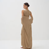Elegant beige sleeveless bodysuit with matching draped shawl wrap, model shown from behind in minimalist setting — Nora The Label | Endless UAE